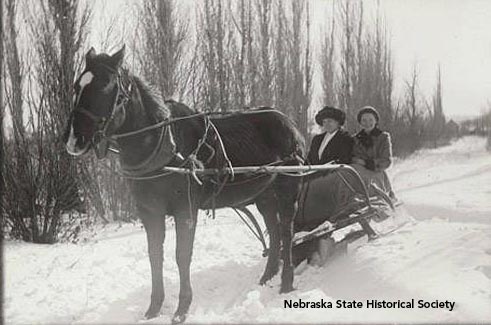John Nelson's photograph of his sister, Hannah Nelson, and his niece, Alice Nelson Dahlesten, in a horse-drawn sleigh, about 1916-18