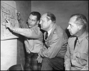 Governor Val Peterson, center, reviewing relief plans during the blizzard of 1949.