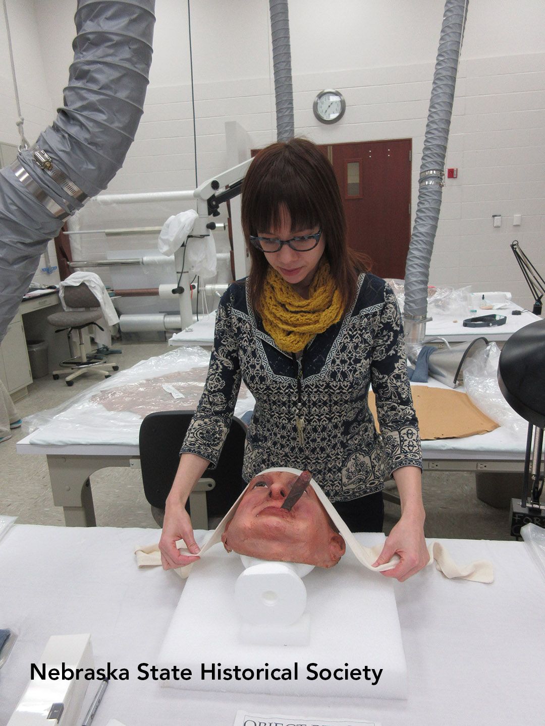 Cashman works on a Doane Powell mask at the Ford Conservation Center.