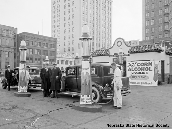 black and white photograph of people at gas station in 1933