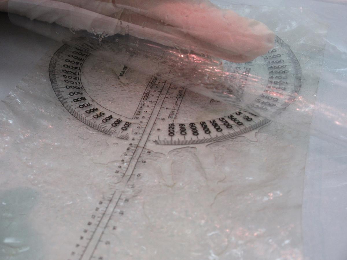 Celluloid Protractor with liquid leaking out