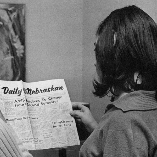 Young woman reading Daily Nebraskan, 1966