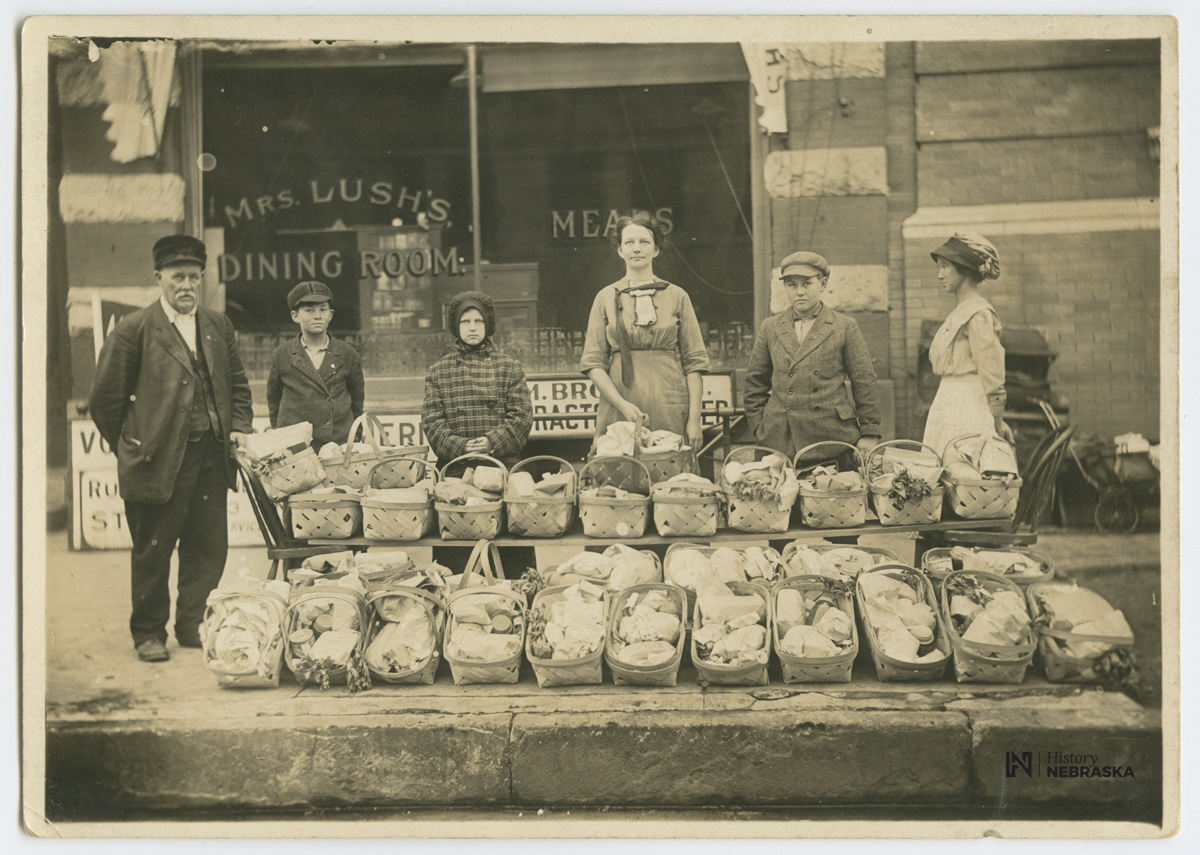 Volunteers of 

<p America distributing baskets for Thanksgiving</p>
<p>Happy Thanksgiving! Today’s Throwback Thursday photograph features members of Volunteers of America ready to distribute Thanksgiving baskets to families in need in 1913.</p>
<p>About thirty baskets have been posed in front of Mrs. Lush’s Dining Room at 1202-1204 P Street in Lincoln, Nebraska. The children in the photograph are reported to be some of the recipients of the bountiful baskets.</p>

			</div>
			</div><div class=