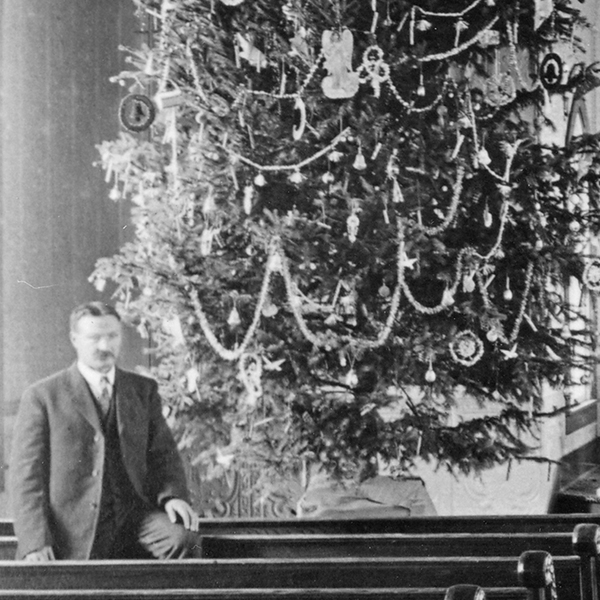 Man beside Christmas tree