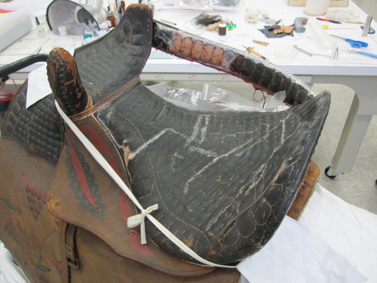 Top of saddle seat showing goldbeater's skin repairs to cracks and losses