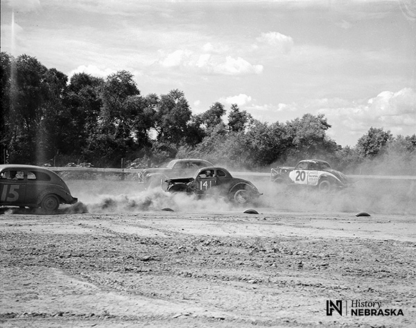 cars racing on dusty track