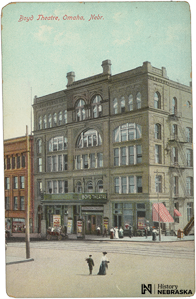 postcard showing five-story brick building