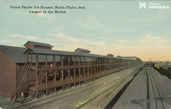 Color postcard of ice houses by RR track: "Union Pacific Ice Houses, North Platte, Neb. Largest in the World."