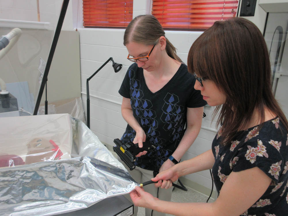 Conservators fill bags with nitrogen