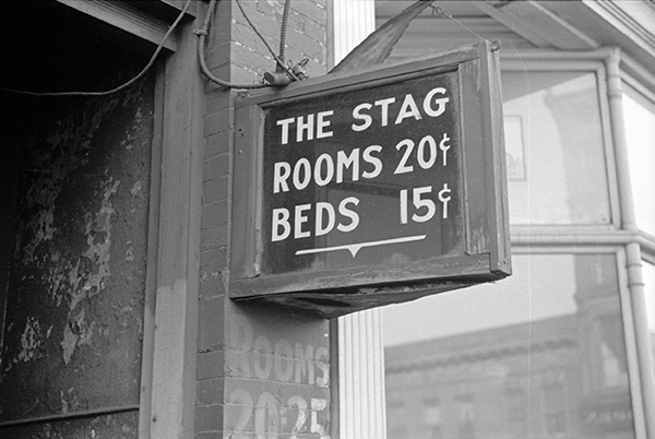 Hotel sign: "The Stag / Rooms 20¢ / Beds 15¢" 