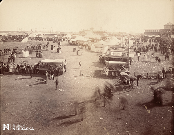 fairgrounds with tents and people