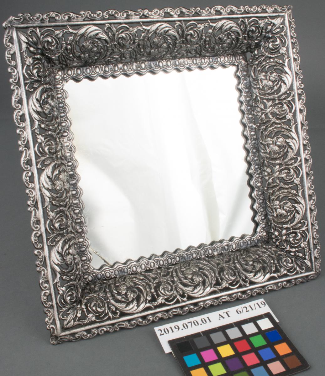after treatment photo of silver framed mirror with leaf and floral border.