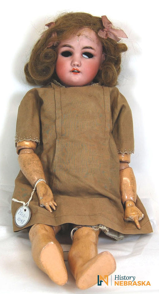 Doll with a blonde wig and brown dress