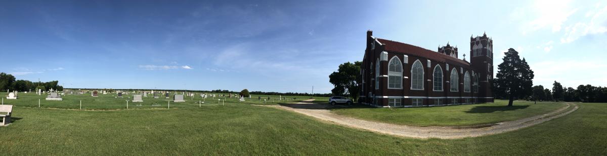 panoramic photo of brick church on the open plains