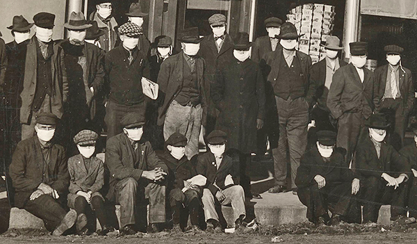 men in surgical masks during 1918 flu pandemic