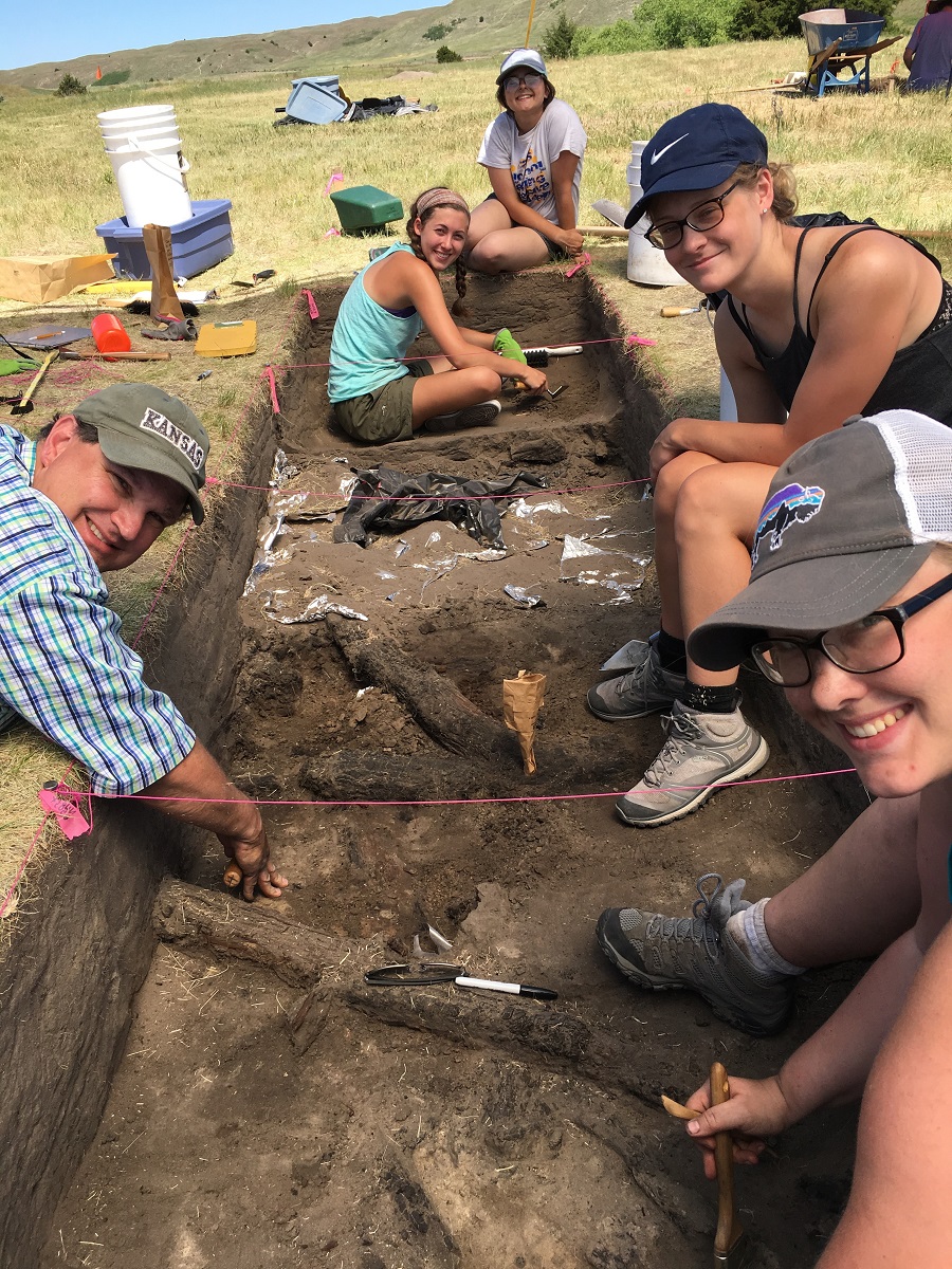 College students excavating the timber ruins of a Ndee lodge