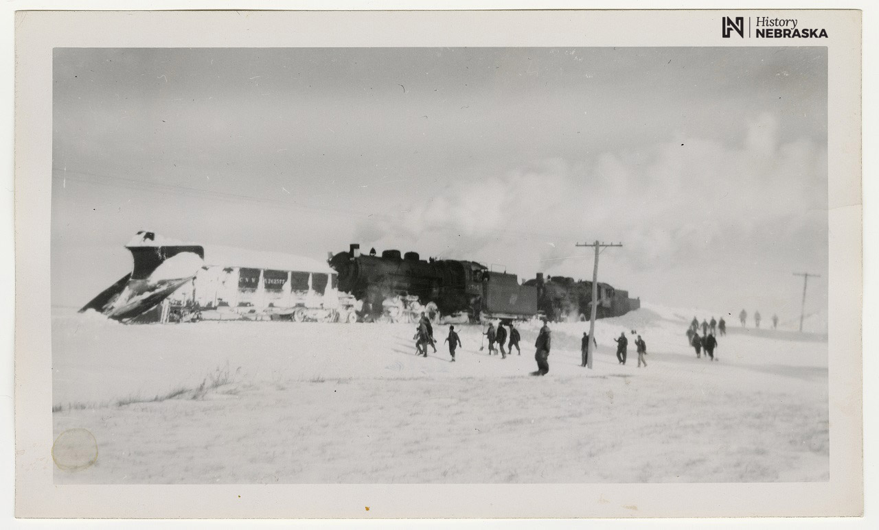 Photo of a railroad locomotive pushing a snow plow through snow