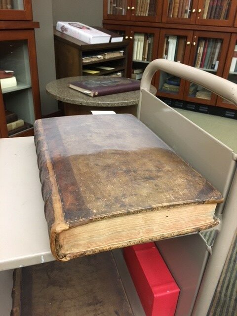 Half of the dust on this book has been removed to show the amount of dust that accumulated on the collection.