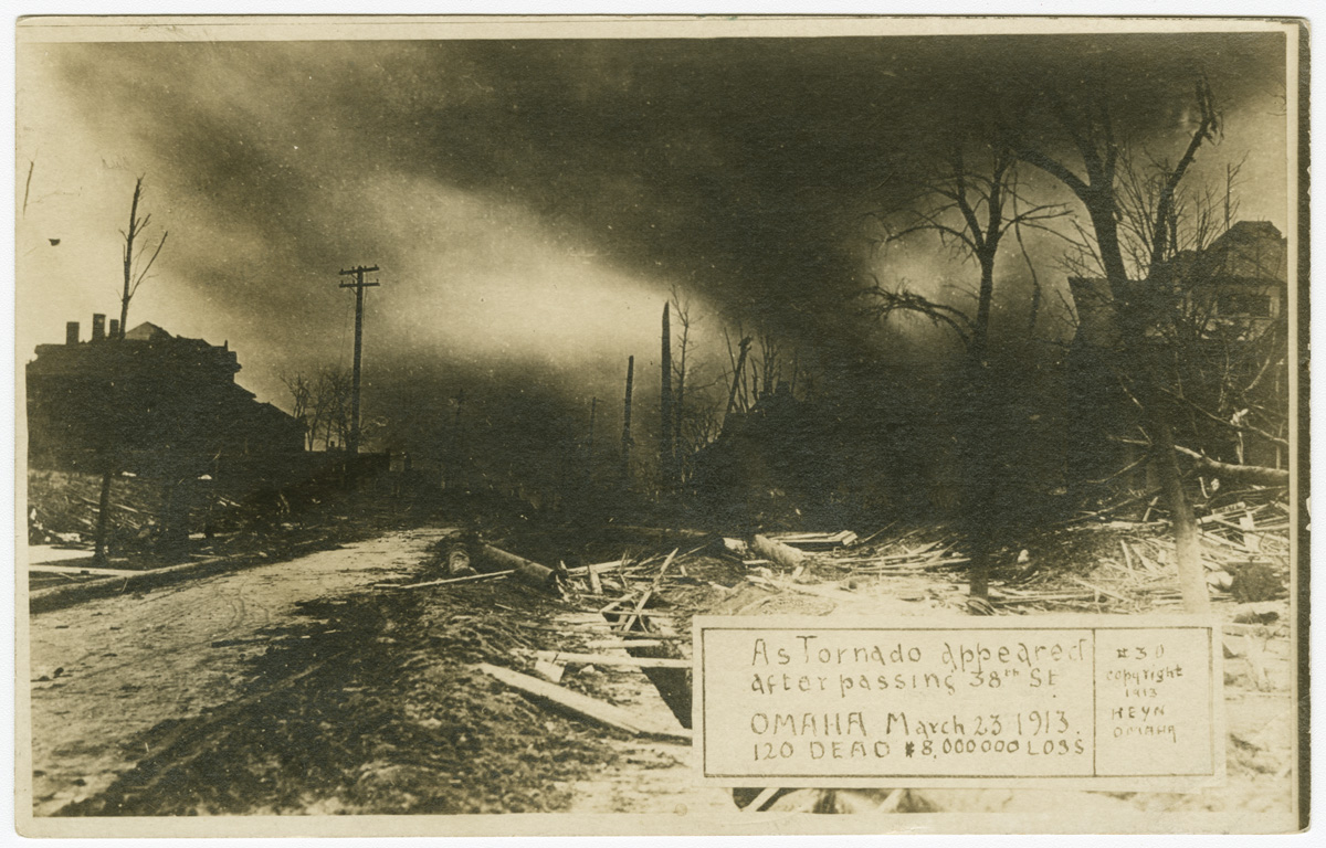 A picture postcard depicting a tornado & the damage in its wake. The caption reads: As tornado appeared after passing 38th St., Omaha March 23, 1913, 120 dead $8,000,000 loss.