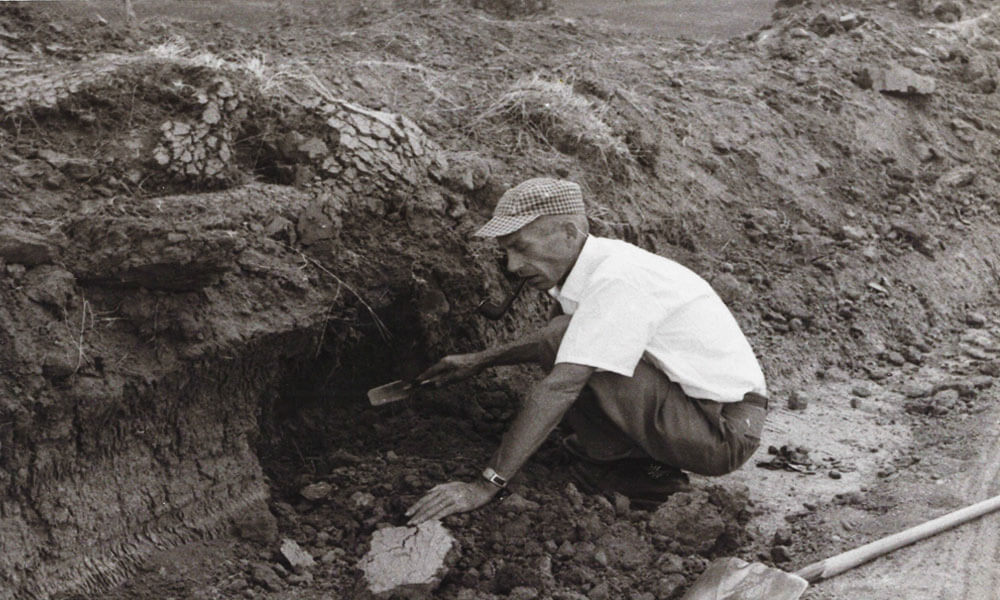 NSHS Archeologist Marvin Kivett testing a shallow pit at the Wright Site in Nance County, 1959 [NSHS 25NC3-150].