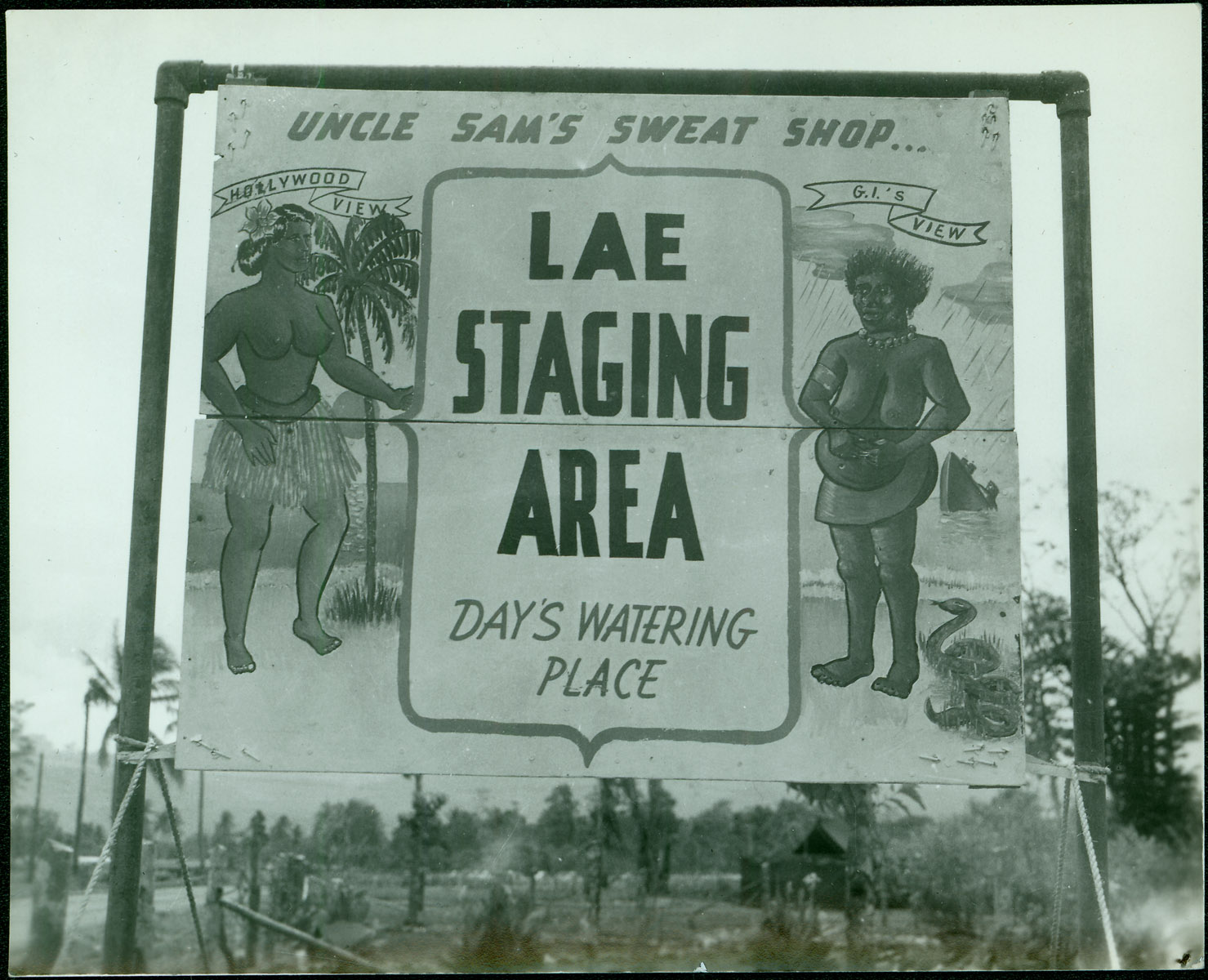 A makeshift billboard outside a U.S. Army base camp depicts two contrasting ideas of army life during the war.