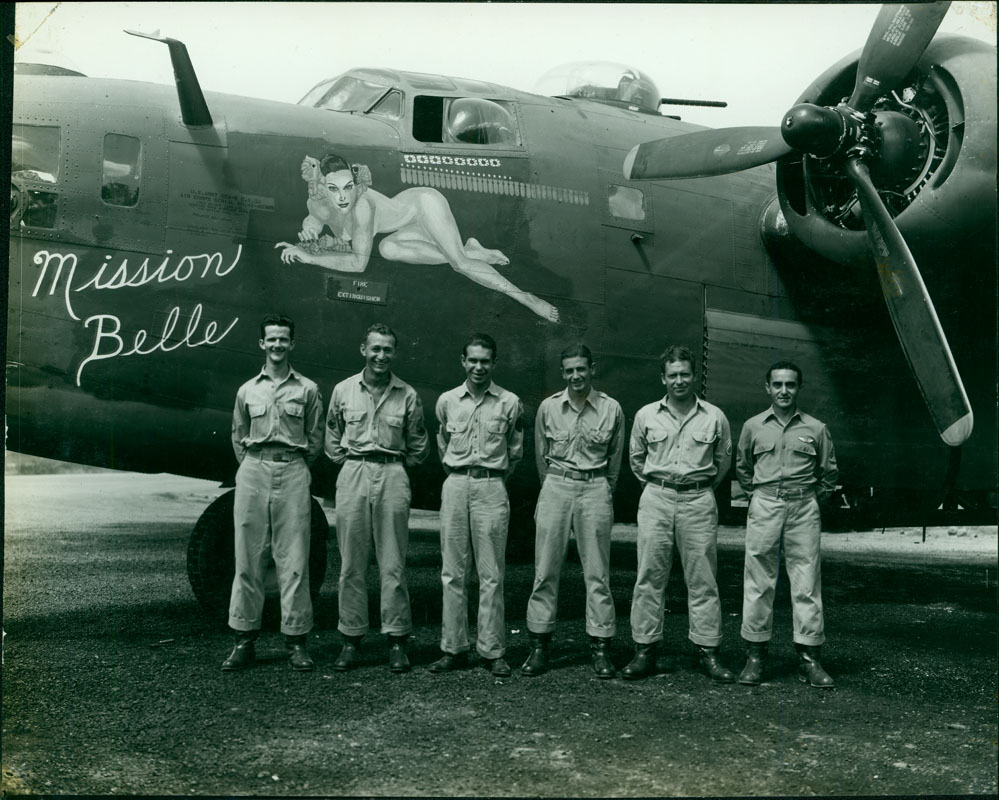 Mission Belle (serial number: 42-40389) - The crew of the B-24 Mission Belle pose by their plane, which features Hedy Lamar’s character Tondelayo from the 1942 film White Cargo.