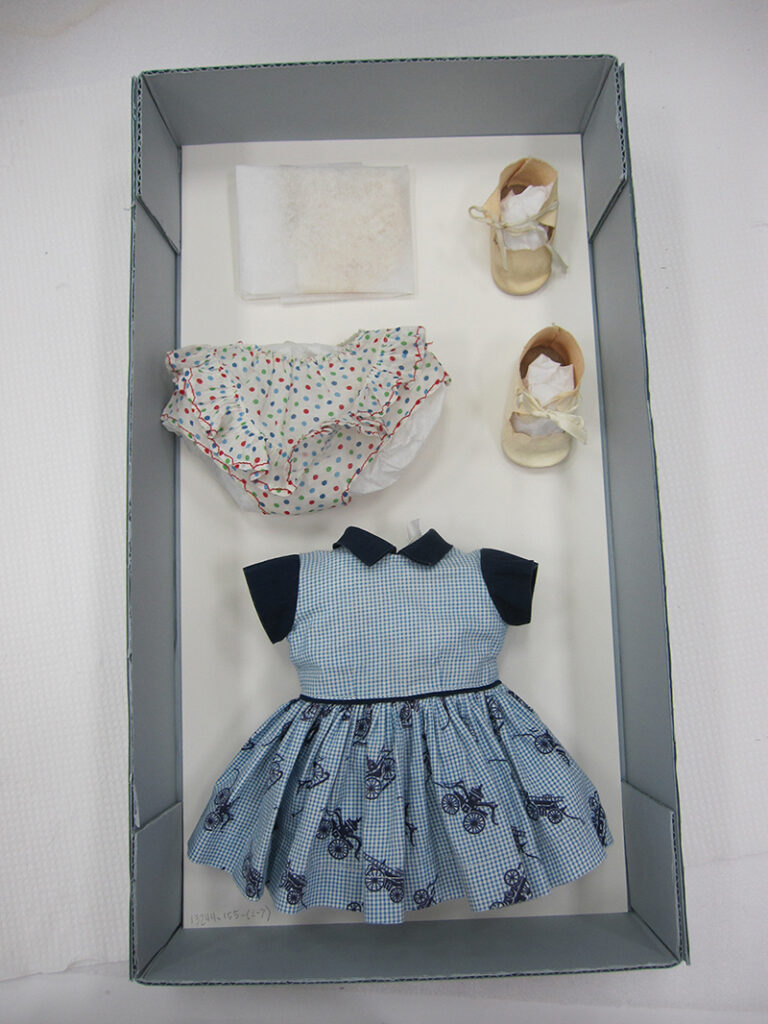 Each doll’s clothing and accessories were removed and placed in a separate tray. The clothing was supported with acid-free, lignin-free tissue paper to reduce creases in the fabric.