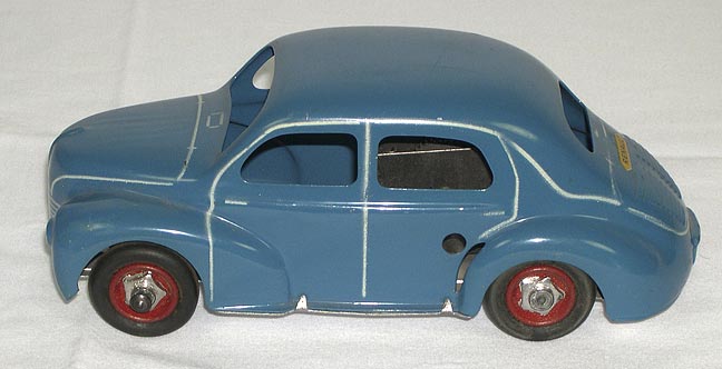 Toy Car (NSHS 7144-102) Windows are empty spaces. Four rubber tires with red metal wheels and shaped silver colored hubcaps. 