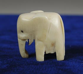 Carved Ivory elephant with black dots for eyes. (NSHS 7144-113)