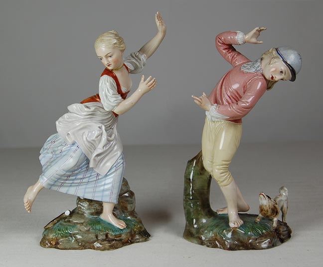 Porcelain figurines of a girl frightened by a snake and of a boy and small dog. (NSHS 7144-149)