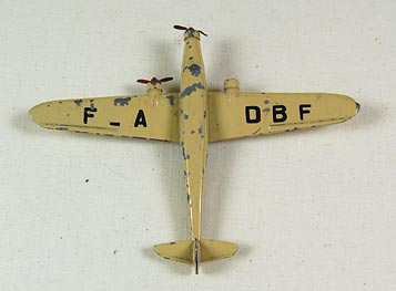 Toy airplane (NSHS 7144-188) Metal toy airplane with two propellers. A third prop, on one of the wing engines is missing. There are decals on the wings. On the left wing it says: "F ­ A". On the right wing it says: "D B F". On the underside of the wings is cast lettering. On the Right wing it says "DINKY TOYS" "DEWOITINE 338". On left wing it says: "MECCANO" "FAB. EN FRANCE".