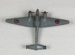 Toy airplane (NSHS 7144-190) Metal toy airplane with French insignia. There are raised letters under the wings that say: "DINKY TOYS, AM109 570?" and "MECCANO, Fabr en France." 