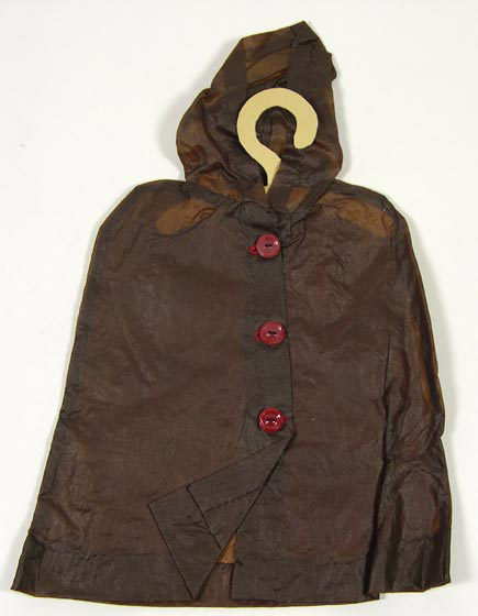 Doll cape (NSHS 7144-193-(1) ) Brown doll cape of impermeable oilskin. 