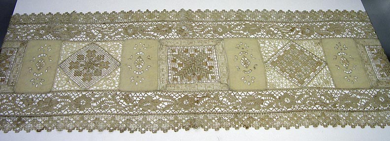 Table runner (NSHS 7144-203)  Table runner with varied and finely detailed lace patterns. 