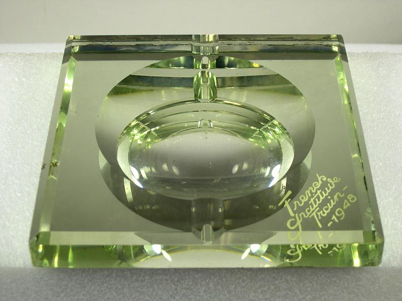 Ashtray (NSHS 7144-212) Cut crystal ashtray with a mirrored base and green felt backing. Etched on one corner of the mirror: "French Gratitude Train." 