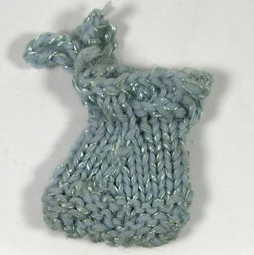 Doll purse (NSHS 7144-32 [dup 3]) Crocheted doll purse with a tag that has the letter "G" on it. 