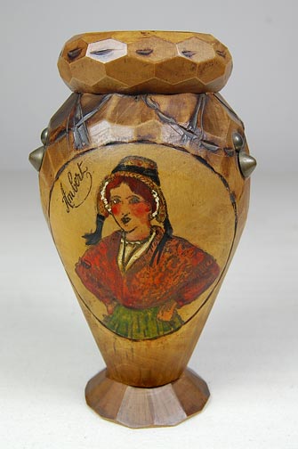 Wood vase with faceted sides and an etching of a woman. "Ambert" is inscribed above the woman. (NSHS 7144-85)
