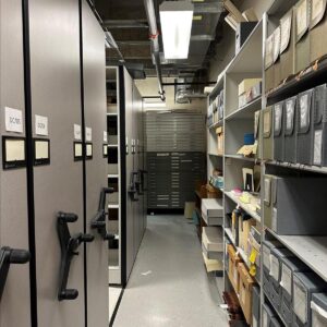 One of the storage areas where History Nebraska collections are stored. There are shelves with various boxes that hold documents, photos, and other archival materials.