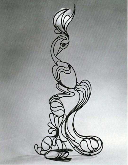 Abstract metal sculpture resembling a stylized bird, composed of curved, flowing lines, set against a plain, light background.