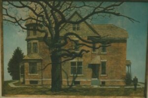A large, old brick house with a turret and gabled roof stands behind a leafless tree; a person is looking at the house from the right side of the image.