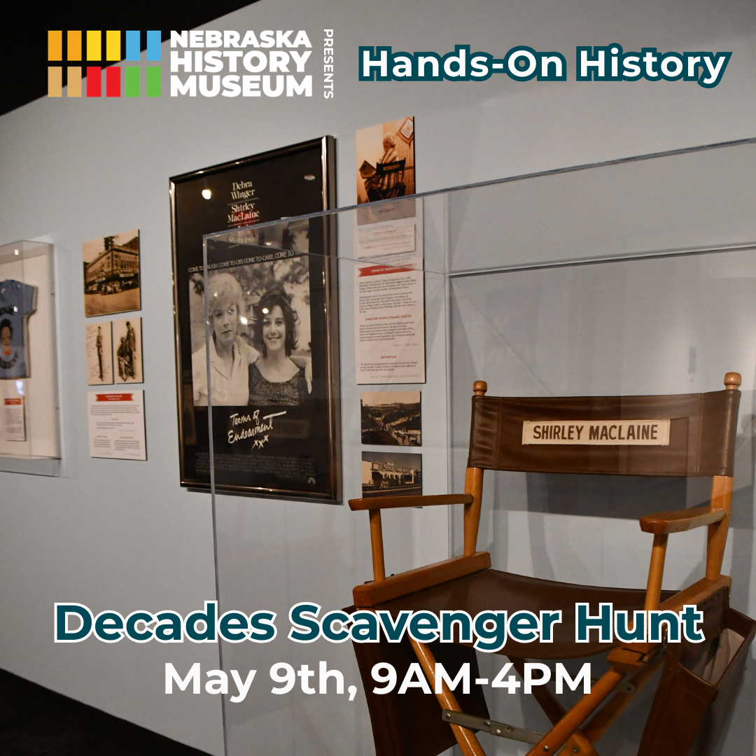 Hands-On History Museum exhibit with film posters, memorabilia, and a director’s chair labeled "Shirley MacLaine." Text promotes "Decades Scavenger Hunt" on May 9th, 9AM-4PM at Nebraska History Museum.