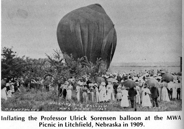 A crowd gathers around as a large balloon is being inflated at the MWA Picnic in Litchfield, Nebraska, in 1909.