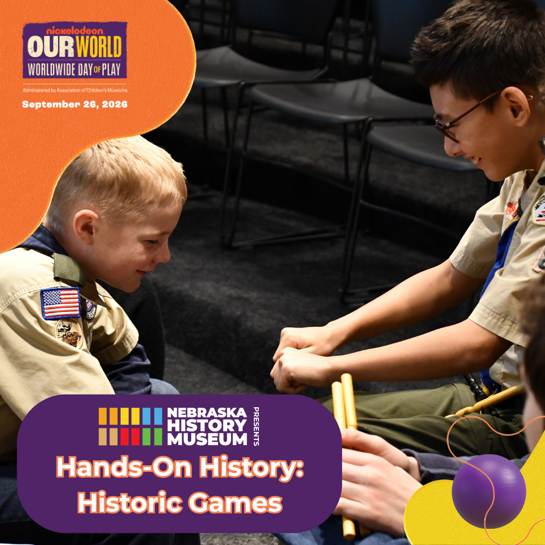 Hands-On History Day of Play Two boys in scout uniforms play a hand-clapping game on stage at the Nebraska History Museum’s Hands-On History: Historic Games event.