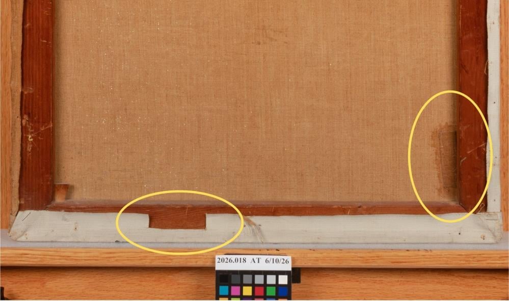 Back of a framed canvas painting with two damaged areas circled in yellow, one on the lower edge and one on the right edge, above a color calibration card.