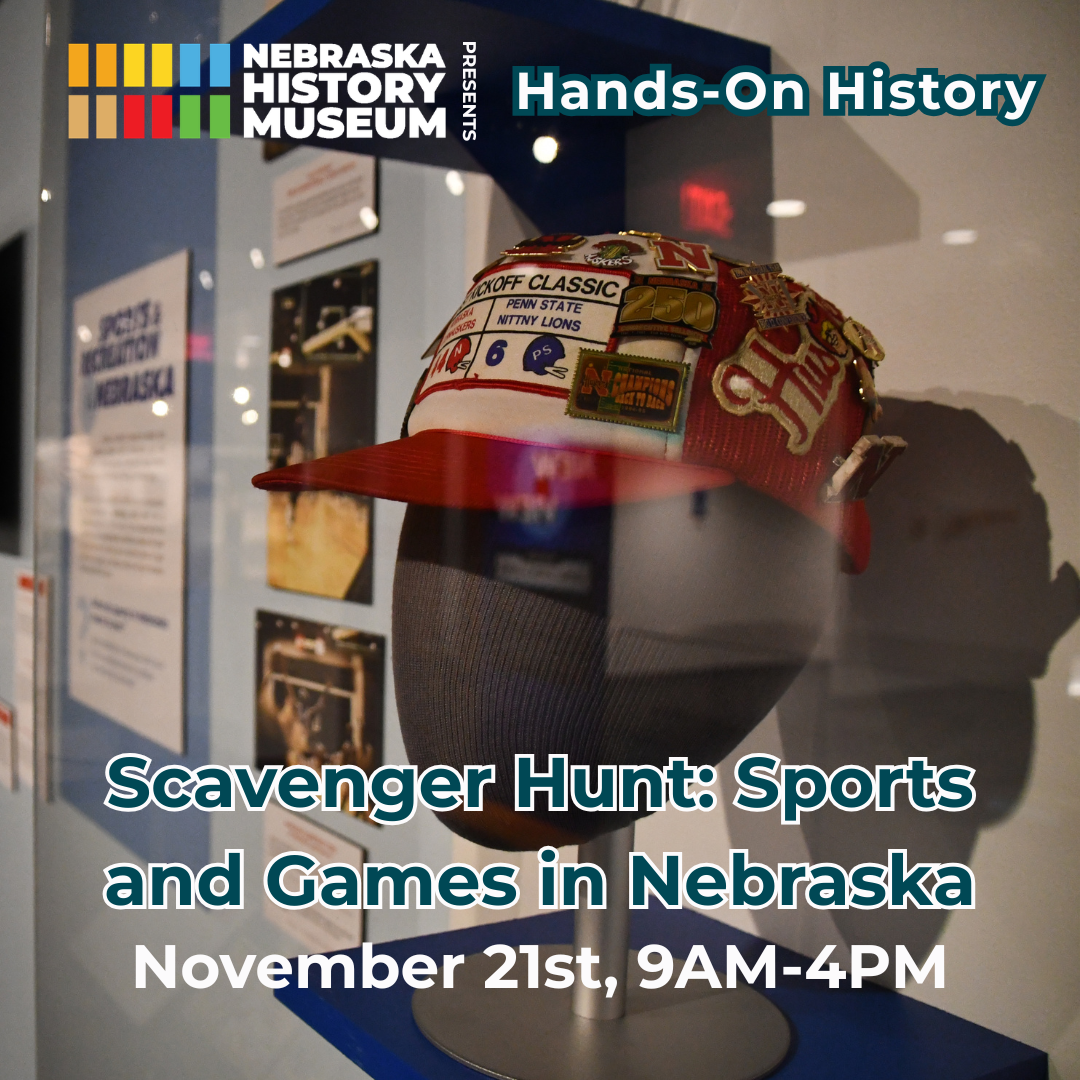 Display case with a decorated sports cap and patches; text promotes a scavenger hunt event at the Nebraska History Museum on November 21st, 9AM–4PM, focused on sports and games in Nebraska.